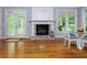 Cozy living room with fireplace, white trim, and a glass dining table next to the covered porch at 5045 Huntwood Way, Roswell, GA 30075
