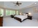 Main bedroom features a tray ceiling, sitting area, and many windows with shutter blinds at 5045 Huntwood Way, Roswell, GA 30075