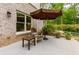Outdoor patio features a cozy seating area with a sun umbrella at 5045 Huntwood Way, Roswell, GA 30075