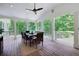 Covered porch with wood floors, dining table, and scenic views at 5045 Huntwood Way, Roswell, GA 30075