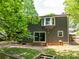 Backyard with a sliding door, steps to grass, and trees, perfect for outdoor enjoyment and relaxation at 555 Creekwood Xing, Roswell, GA 30076