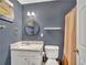 Updated bathroom with granite vanity top, framed round mirror, and a shower with neutral colored curtain at 555 Creekwood Xing, Roswell, GA 30076