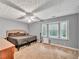 Spacious bedroom featuring a large bay window, plush carpet, and neutral paint tones at 555 Creekwood Xing, Roswell, GA 30076