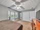 Spacious bedroom featuring a ceiling fan, a bay window seat, and double door closets for ample storage at 555 Creekwood Xing, Roswell, GA 30076