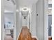 Hallway with hardwood floors connects various rooms, creating an open and inviting flow throughout the home at 555 Creekwood Xing, Roswell, GA 30076