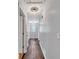 Bright hallway featuring wood flooring, white walls, and modern lighting at 555 Creekwood Xing, Roswell, GA 30076