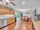 Open kitchen and dining area features warm wood floors, shaker cabinets, granite countertops, and stainless appliances at 555 Creekwood Xing, Roswell, GA 30076