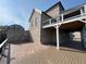 Multi-level backyard with deck, patio, and brick facade at 5753 Brendlynn Dr, Suwanee, GA 30024