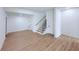 Open basement area showcasing new hardwood floors, staircase, and plenty of space at 5753 Brendlynn Dr, Suwanee, GA 30024