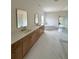 Bright bathroom with double vanity, soaking tub, walk-in shower, and marble flooring at 5753 Brendlynn Dr, Suwanee, GA 30024