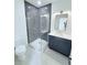 Modern bathroom showcasing a glass-enclosed shower with gray tile and a sleek vanity at 5753 Brendlynn Dr, Suwanee, GA 30024