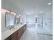 Luxurious bathroom with double vanity, soaking tub, glass shower, and marble tile floor at 5753 Brendlynn Dr, Suwanee, GA 30024