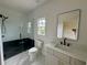 This bathroom features a glass shower, marble floors, and a modern sink at 5753 Brendlynn Dr, Suwanee, GA 30024