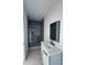 Bathroom featuring shower with glass door and white vanity at 5753 Brendlynn Dr, Suwanee, GA 30024