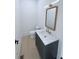 Stylish powder room with elegant mirror, marble countertop, contemporary sink, and sleek finishes at 5753 Brendlynn Dr, Suwanee, GA 30024