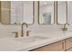 Modern bathroom featuring a double vanity with quartz countertops and gold faucets at 5753 Brendlynn Dr, Suwanee, GA 30024