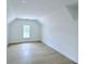 Bright, airy bedroom with hardwood floors and a large window at 5753 Brendlynn Dr, Suwanee, GA 30024