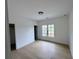 Bedroom with hardwood floors, white walls, and a large window with natural light at 5753 Brendlynn Dr, Suwanee, GA 30024