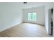 Bedroom with wood floors and large window at 5753 Brendlynn Dr, Suwanee, GA 30024