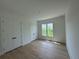 Bedroom with wood floors and large windows at 5753 Brendlynn Dr, Suwanee, GA 30024