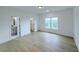 Light-filled bedroom with hardwood floors, showcasing ensuite bathroom and window views at 5753 Brendlynn Dr, Suwanee, GA 30024