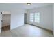 Bright bedroom features wood floors, a window with neighborhood views, and closet at 5753 Brendlynn Dr, Suwanee, GA 30024