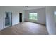 This bedroom has hardwood floors, a window, a closet, and a bathroom at 5753 Brendlynn Dr, Suwanee, GA 30024