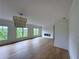 Bright and airy bedroom features a modern light fixture, fireplace, and large windows overlooking the outdoors at 5753 Brendlynn Dr, Suwanee, GA 30024