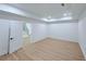 Spacious bedroom with hardwood floors, recessed lighting, and a staircase visible through the open doorway at 5753 Brendlynn Dr, Suwanee, GA 30024