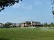 Well-maintained clubhouse with manicured green lawn, golf course views, and ample parking at 5753 Brendlynn Dr, Suwanee, GA 30024