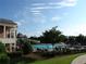 Large community pool area featuring a slide, clubhouse, and lounge chairs for residents' enjoyment at 5753 Brendlynn Dr, Suwanee, GA 30024