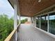 A covered deck features wood ceiling, brick pillars, and scenic backyard views at 5753 Brendlynn Dr, Suwanee, GA 30024