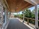 Beautiful covered deck with wood ceiling, fan, outdoor living space, and black aluminum railings at 5753 Brendlynn Dr, Suwanee, GA 30024