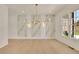 Elegant dining room featuring a modern chandelier and decorative marble wall at 5753 Brendlynn Dr, Suwanee, GA 30024