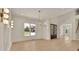 Open-concept dining area with modern lighting and a view of the home's entrance at 5753 Brendlynn Dr, Suwanee, GA 30024