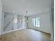Elegant dining room with marble accent wall and stylish modern chandelier at 5753 Brendlynn Dr, Suwanee, GA 30024