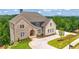 Stunning two-story brick home with a well-manicured lawn and lush landscaping at 5753 Brendlynn Dr, Suwanee, GA 30024