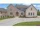 Beautiful home with a brick and stone exterior, complemented by professional landscaping at 5753 Brendlynn Dr, Suwanee, GA 30024