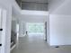Open foyer showcasing hardwood floors, a view to the living space, and an open staircase at 5753 Brendlynn Dr, Suwanee, GA 30024