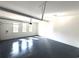 Spacious garage with epoxy flooring and natural light coming through the three windows at 5753 Brendlynn Dr, Suwanee, GA 30024