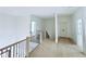 Open hallway with hardwood floors and black metal railings at 5753 Brendlynn Dr, Suwanee, GA 30024