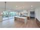 Gourmet kitchen featuring a large island and views to an outdoor entertainment area at 5753 Brendlynn Dr, Suwanee, GA 30024