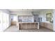 Bright kitchen with island seating, modern appliances, and ample cabinet space at 5753 Brendlynn Dr, Suwanee, GA 30024