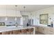 Beautiful kitchen with waterfall edge island seating and neutral decor at 5753 Brendlynn Dr, Suwanee, GA 30024