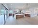 Spacious kitchen with large island, custom cabinets, and sliding glass doors at 5753 Brendlynn Dr, Suwanee, GA 30024