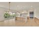 Open-concept kitchen with island, stainless steel appliances and light hardwood floors at 5753 Brendlynn Dr, Suwanee, GA 30024