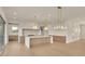 Spacious open kitchen with a large island, modern appliances, and stylish light fixtures at 5753 Brendlynn Dr, Suwanee, GA 30024