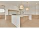 Open-concept kitchen with stainless steel appliances and light hardwood floors at 5753 Brendlynn Dr, Suwanee, GA 30024