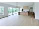 Bright, open kitchen features a large island, wood cabinets, and a seamless transition to a deck at 5753 Brendlynn Dr, Suwanee, GA 30024
