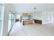 Bright, open kitchen boasts a large island, wood cabinets, and doors to a deck with scenic views at 5753 Brendlynn Dr, Suwanee, GA 30024
